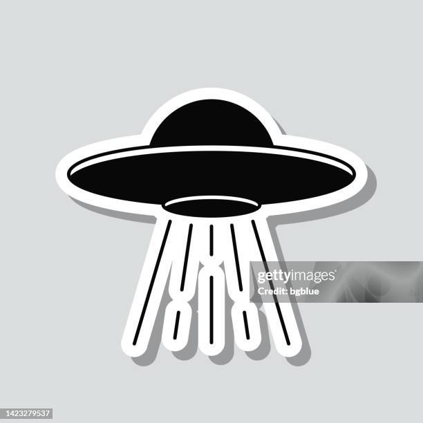 ufo - flying saucer with light beam. icon sticker on gray background - ufo saucer stock illustrations