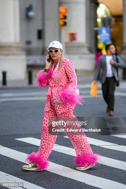 Guest wears a white cap, white cat eyes sunglasses, diamond earrings, multicolored pearls necklaces, a beige with neon pink polka dots print pattern...