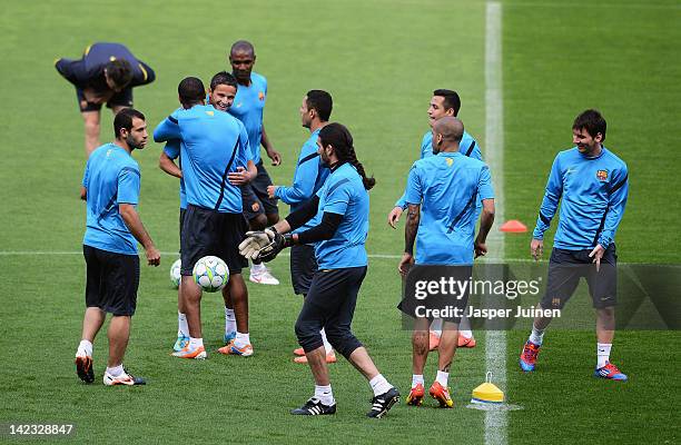 Ibrahim Afellay of FC Barcelona is embraced by Seydou Keita as he is welcomed back after a long injury by his teammates, with Javier Mascherano and...