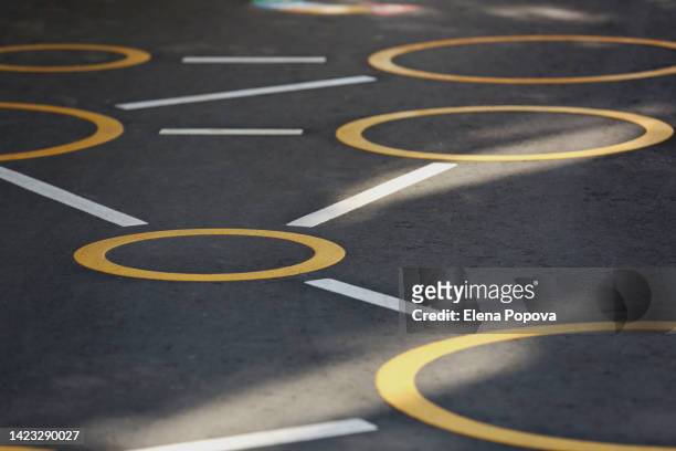 close up hopscotch game drawing at the asphalt road on sunny summer day - aerial view of childs playground stock pictures, royalty-free photos & images