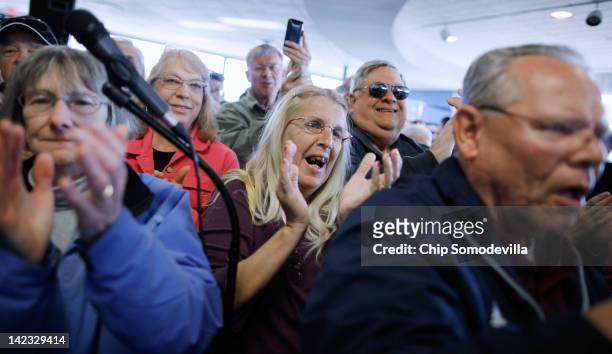 Supporters applaud for Republican presidential candidate, former House Speaker Newt Gingrich and his wife Callista Gingrich during a campaign event...