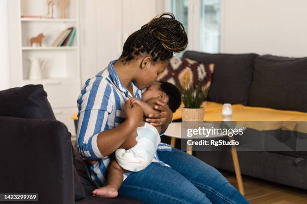 Mother Rocking Mother Rocking Baby To Sleep Photos and Premium High Res Pictures ...
