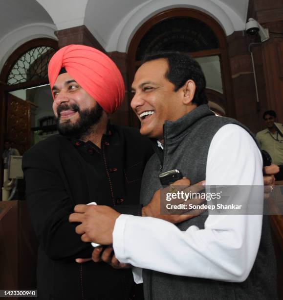 Former cricket team mates Mohammad Azaharuddin and Navjyot Sidhu, now MP's from Congress and BJP outside Parliament on Thursday November 25, 2010.