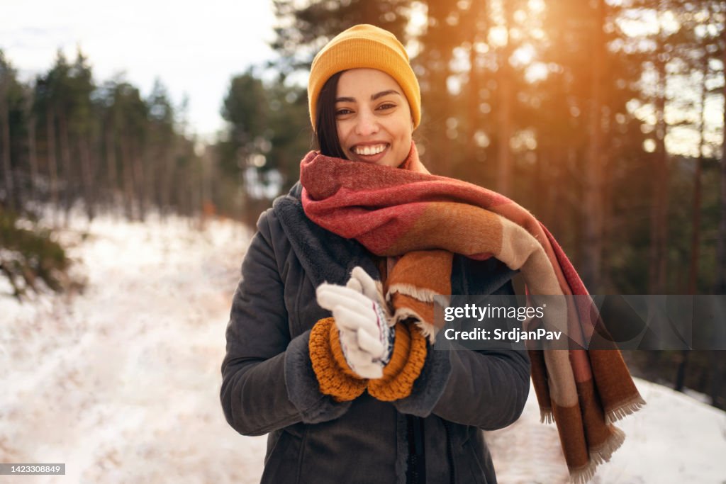Beautiful young Caucasian woman in nature during winter