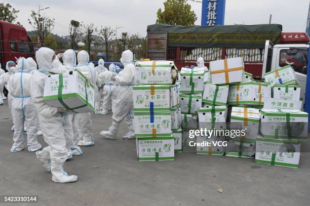 Volunteers unload vegetables from a truck to meet local residents' needs amid the COVID-19 epidemic on September 12, 2022 in Guiyang, Guizhou...