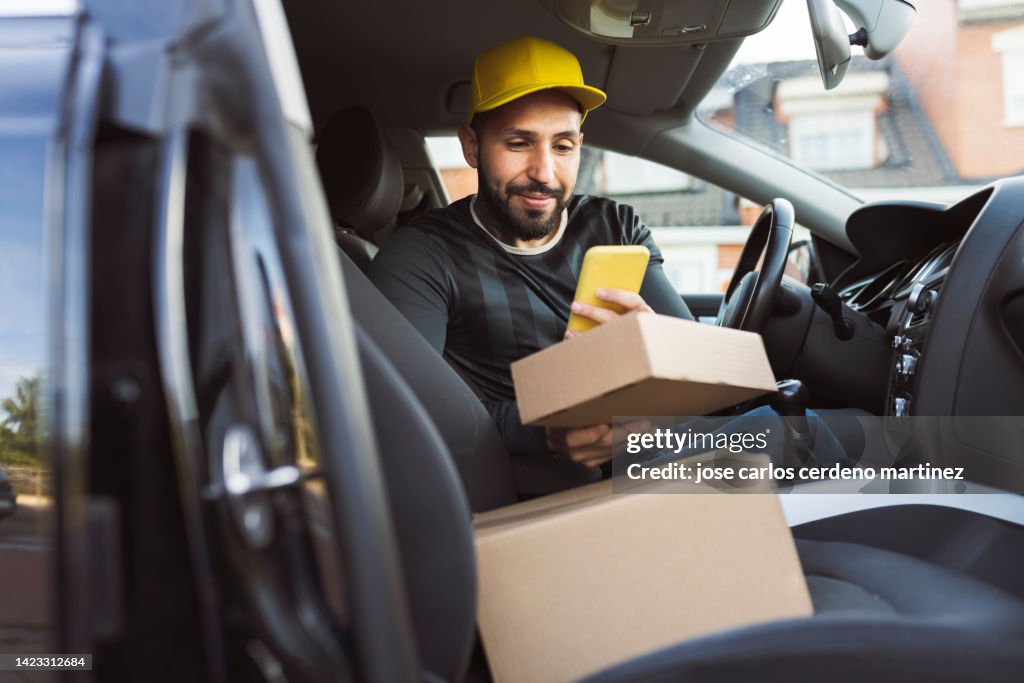 Delivery man in truck with packages