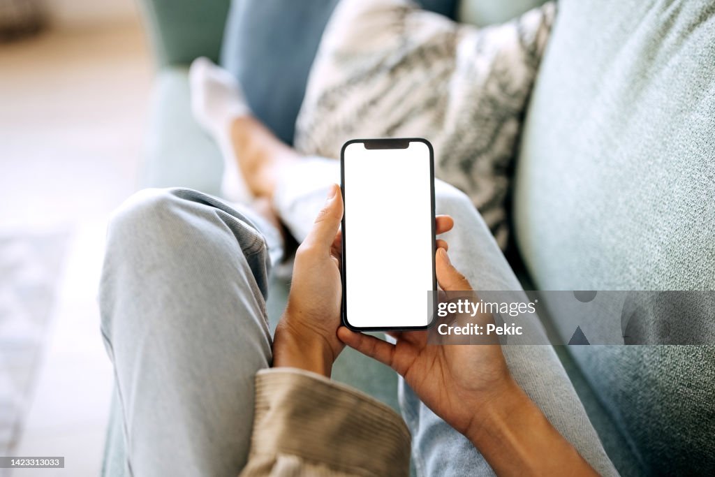 Unrecognisable woman holding smart phone with white screen