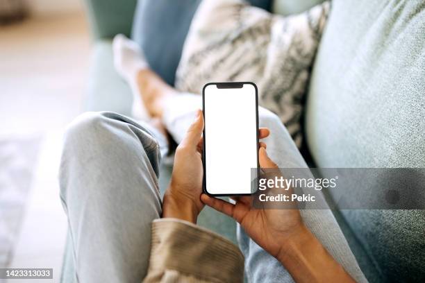 unrecognisable woman holding smart phone with white screen - holding stock pictures, royalty-free photos & images
