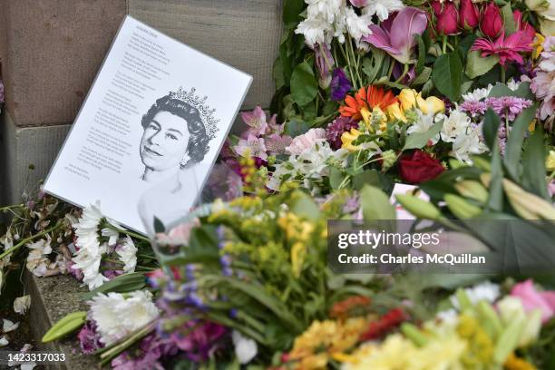 Portrait of the late Queen Elizabeth II sits amongst floral tributes at Hillsborough Castle on September 13, 2022 in Belfast, Northern Ireland. King...