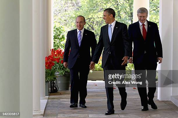 President Barack Obama , Canadian Prime Minister Stephen Harper , and Mexican President Felipe Calderon walk to a joint press conference in the Rose...