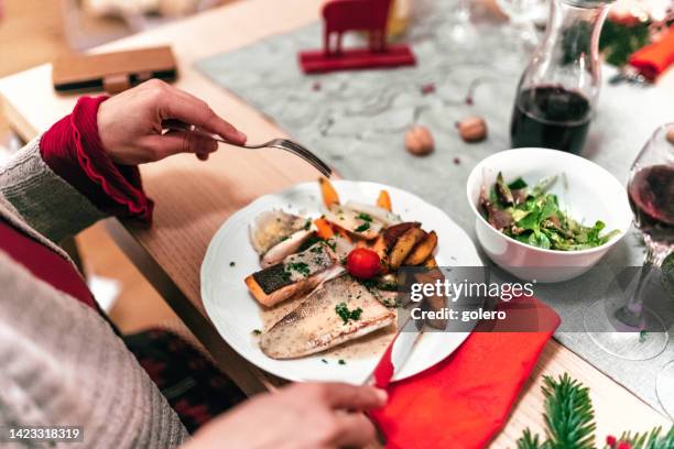 dining fish at christmas table - diner plates stock pictures, royalty-free photos & images