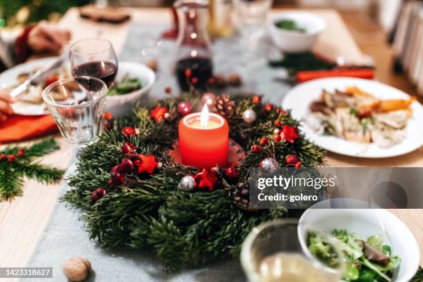 dining at christmas table - advent wreath stock pictures, royalty-free photos & images