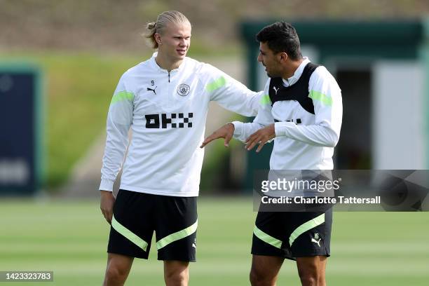 Erling Haaland and Rodrigo of Manchester City interact during a training session ahead of their UEFA Champions League group G match against Borussia...