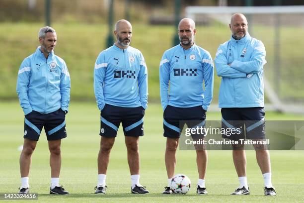 Pep Guardiola, Manager of Manchester City and staff look on during a training session ahead of their UEFA Champions League group G match against...