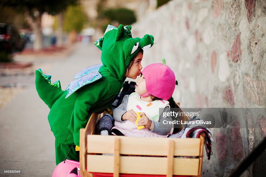 Toddler dressed as dragon and cupcake