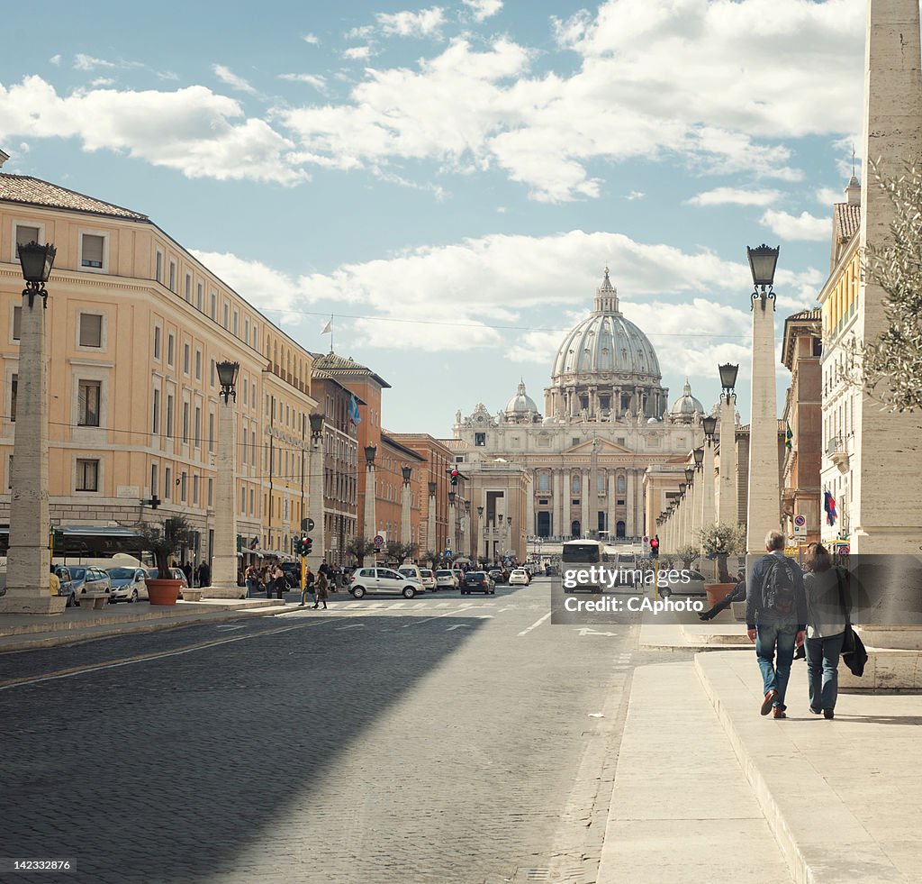 Couple walking on sidewalk in Rome