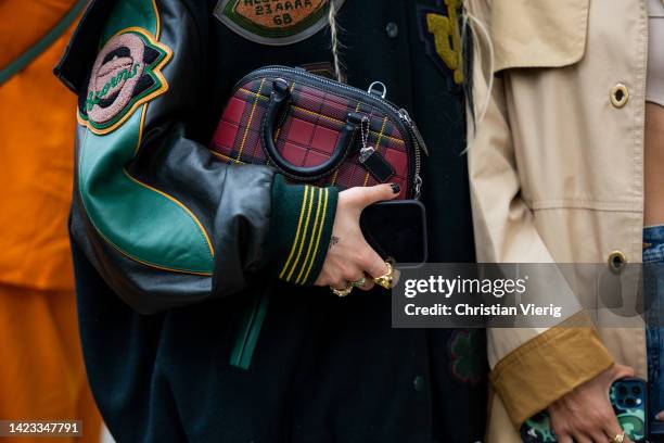 Guest wearing bag outside Coach on September 12, 2022 in New York City.