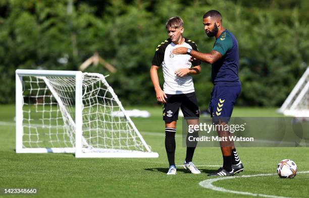 First Team Coach Carl Martin speaks to Dominic Ballard during a Southampton FC training session at the Staplewood Campus on September 12, 2022 in...