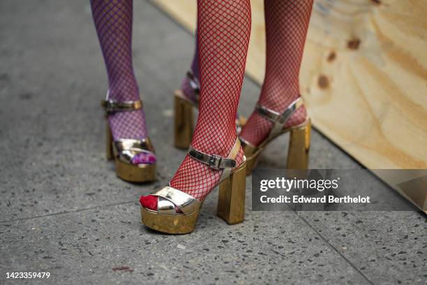Ami wears purple fishnet tights, gold shiny varnished leather heels shoes ; Aya wears red fishnet tights, gold shiny leather strappy heels sandals ,...