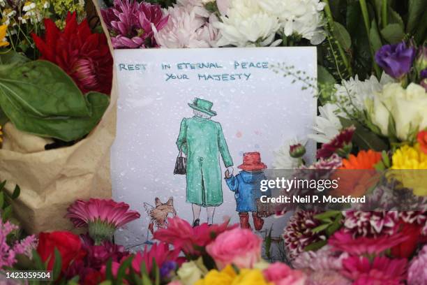 Flowers and Paddington Bear themed tributes at The Long Walk gates in front of Windsor Castle on September 13, 2022 in Windsor, England. Elizabeth...