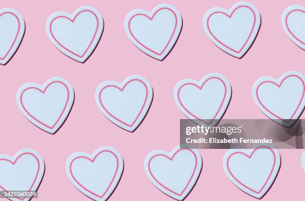 seamless pattern of white hearts on pink background - love heart sweets stock pictures, royalty-free photos & images