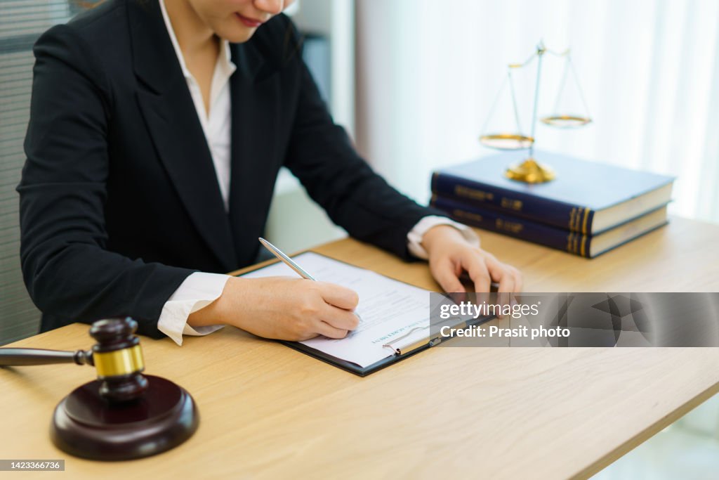 Lawyer businesswoman working and notary signs the documents at office. consultant lawyer, justice and law ,attorney, court judge, concept.