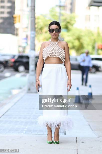 Cici Celia is seen wearing Pearlia Studio top and skirt, Amina Mauddi shoes, Dior sunglasses and Mam accessories outside the Veronica Beard show...