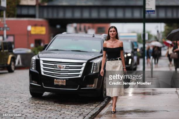 Ilirida Krasniqi seen wearing a beige long skirt, a black off-shoulder shirt, black belt and black handbag outside Khaite during New York Fashion...