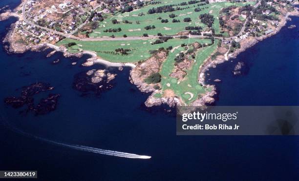 Boat motors past a peninsula near Victoria, September 14, 1996 in Victoria, B.C., Canada.