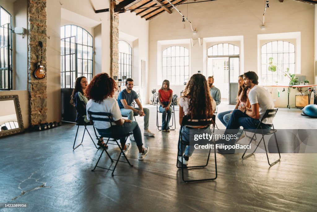 Group therapy session with people talking together