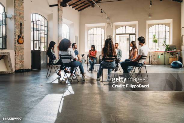 group therapy session with people talking together - aa meeting stock pictures, royalty-free photos & images