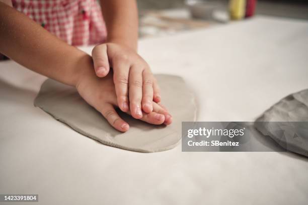 little girl playing with clay - clay stock-fotos und bilder