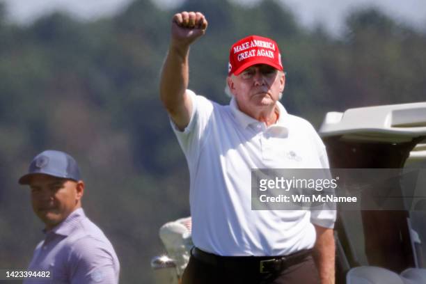 Former U.S. President Donald Trump gestures while golfing at Trump National Golf Club September 13, 2022 in Sterling, Virginia.