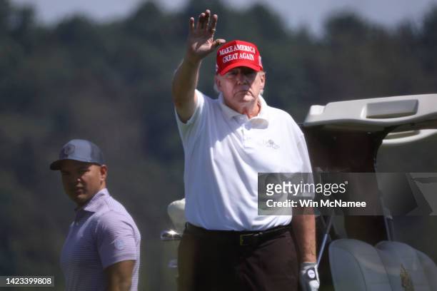 Former U.S. President Donald Trump gestures while golfing at Trump National Golf Club September 13, 2022 in Sterling, Virginia. Trump's legal team is...