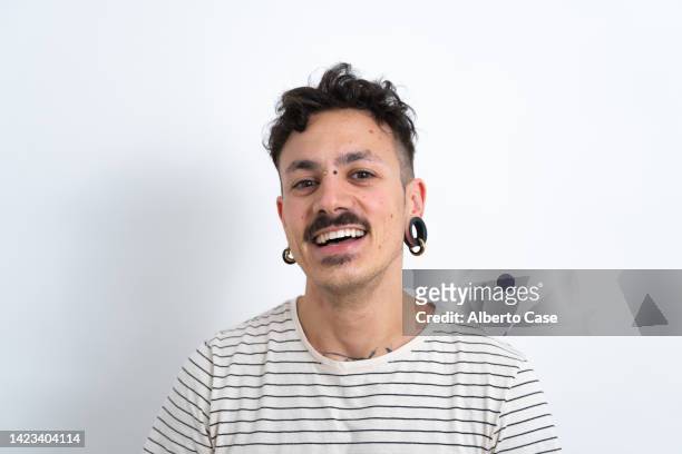 man in a white photo studio smiling and looking at the camera - handsome tattoo stock pictures, royalty-free photos & images
