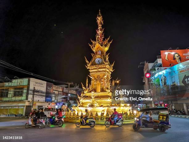 thai style gold clock tower in chiang rai at night - chiang rai province stock pictures, royalty-free photos & images