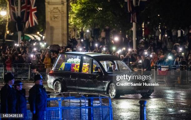 The hearse carrying the flag-draped casket of Queen Elizabeth II arrives at Buckingham Palace on September 13, 2022 in London, England. Queen...