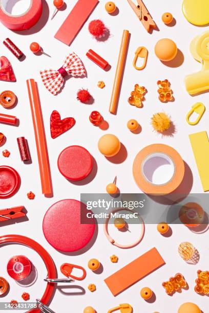 red and orange color gradient sewing items flat lay on pink - multi coloured buttons stock pictures, royalty-free photos & images