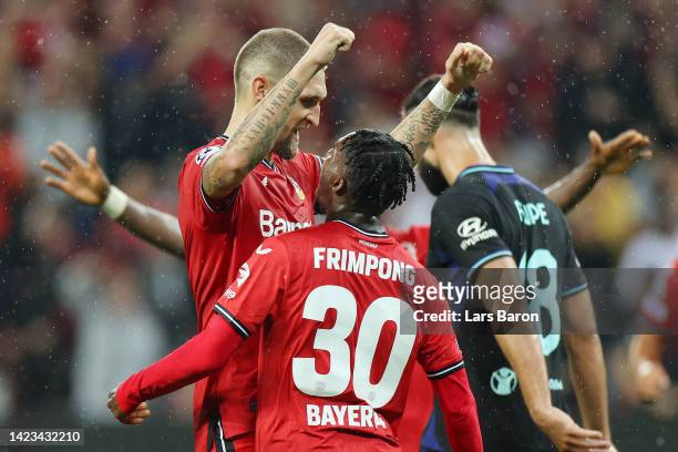 Robert Andrich of Bayer Leverkusen celebrates with teammate Jeremie Frimpong after scoring their team's first goal during the UEFA Champions League...