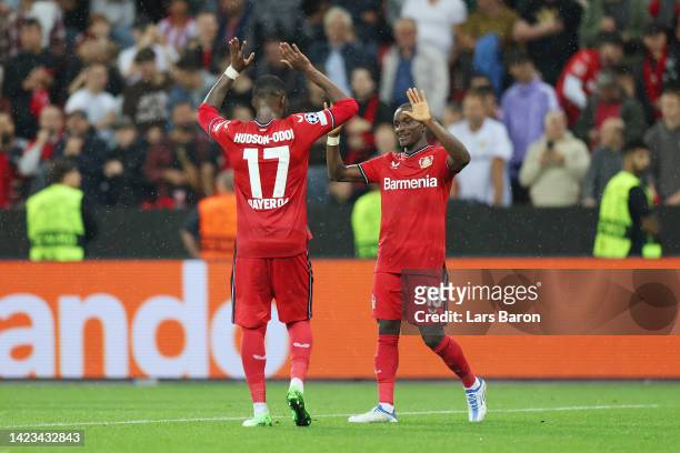 Moussa Diaby of Bayer Leverkusen celebrates with teammate Callum Hudson-Odoi after scoring their team's second goal during the UEFA Champions League...