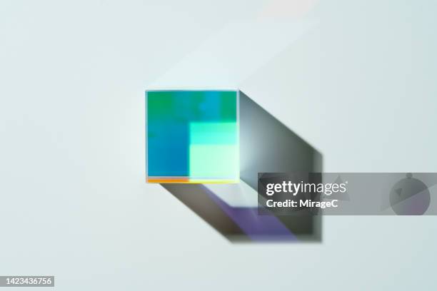 a cube prism refracting green light - prism stock pictures, royalty-free photos & images