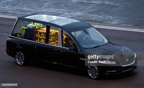 The coffin of Queen Elizabeth II is transferred by the Royal hearse after leaving the RAF aircraft at RAF Northolt on September 13, 2022 in London,...