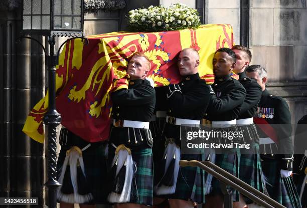 The coffin of Queen Elizabeth II is carried into St Giles Cathedral, after making its way along The Royal Mile on September 12, 2022 in Edinburgh,...