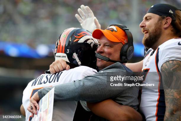 Head coach Nathaniel Hackett of the Denver Broncos celebrates a touchdown with Russell Wilson during the second quarter against the Seattle Seahawks...