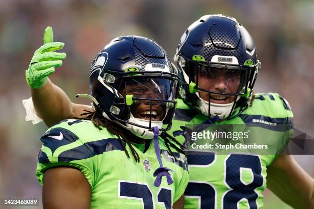DeeJay Dallas and Tanner Muse of the Seattle Seahawks look on during the fourth quarter against the Denver Broncos at Lumen Field on September 12,...