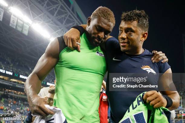 Metcalf of the Seattle Seahawks and Russell Wilson of the Denver Broncos greet one another after the game at Lumen Field on September 12, 2022 in...