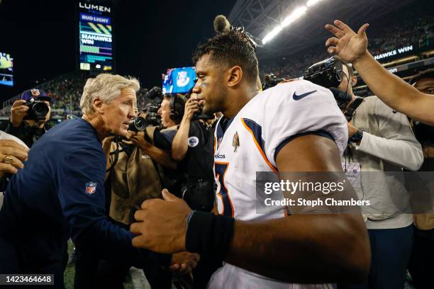 Head coach Pete Carroll of the Seattle Seahawks and Russell Wilson of the Denver Broncos shake hands after their game at Lumen Field on September 12,...