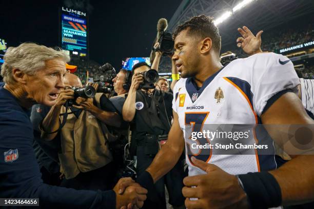 Head coach Pete Carroll of the Seattle Seahawks and Russell Wilson of the Denver Broncos shake hands after their game at Lumen Field on September 12,...