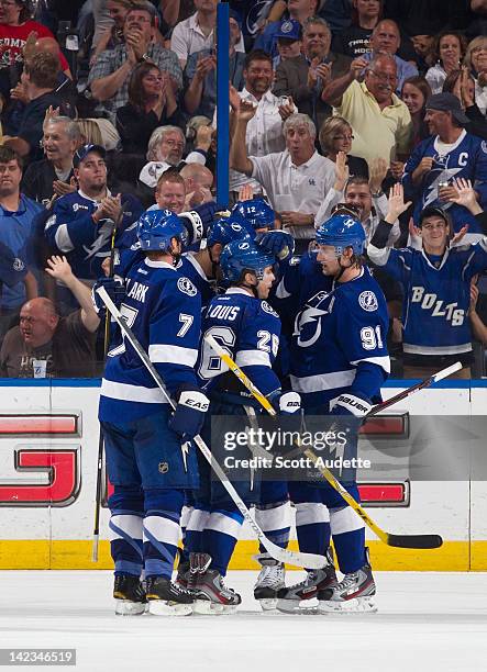 Teddy Purcell of the Tampa Bay Lightning celebrates his goal with teammates Brett Clark, Martin St. Louis and Steven Stamkos during the second period...