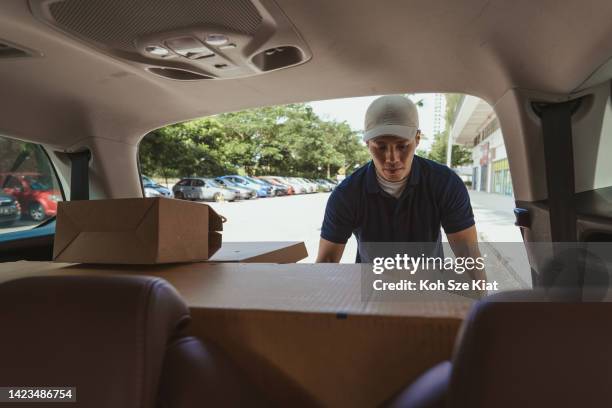 gig economy - asian man doing part time delivery of parcels using a car - sharing economy stock pictures, royalty-free photos & images